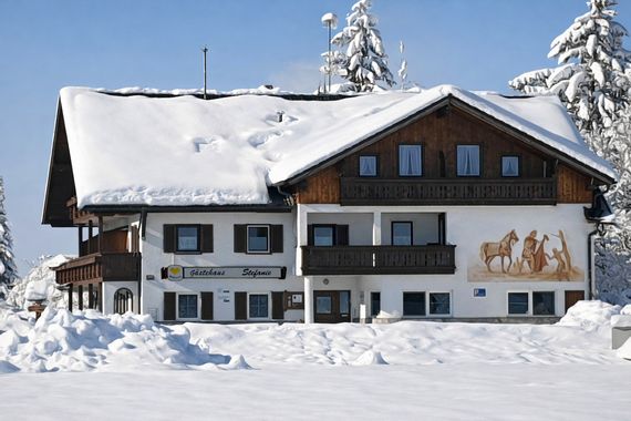 Guesthouse Stefanie in Schwangau-Brunnen with snow-covered roof in winter